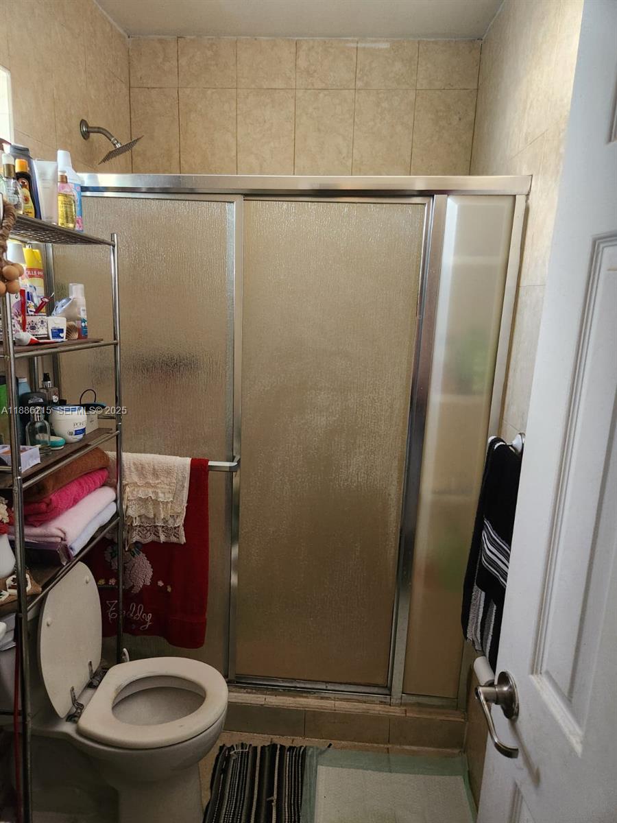 614 East 56th Street Hialeah, FL 33013 - Photo 24 of 78 a bathroom with a toilet and a shower