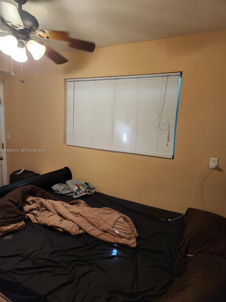 614 East 56th Street Hialeah, FL 33013 - Photo 33 of 78 a bed sitting in a bedroom next to a lamp
