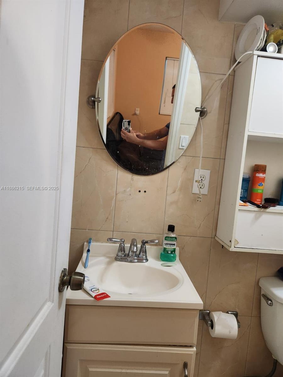 614 East 56th Street Hialeah, FL 33013 - Photo 35 of 78 a bathroom with a sink and a mirror