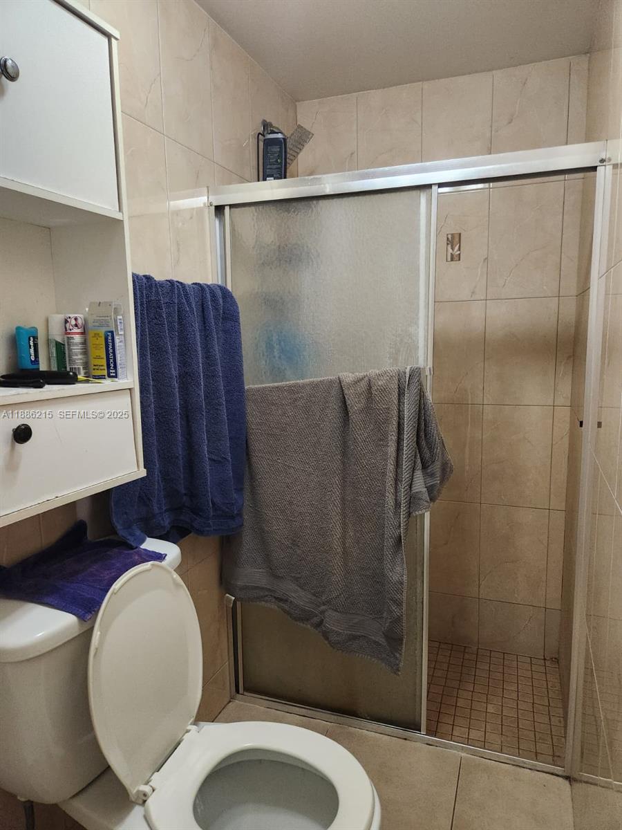614 East 56th Street Hialeah, FL 33013 - Photo 36 of 78 a bathroom with a toilet and a shower