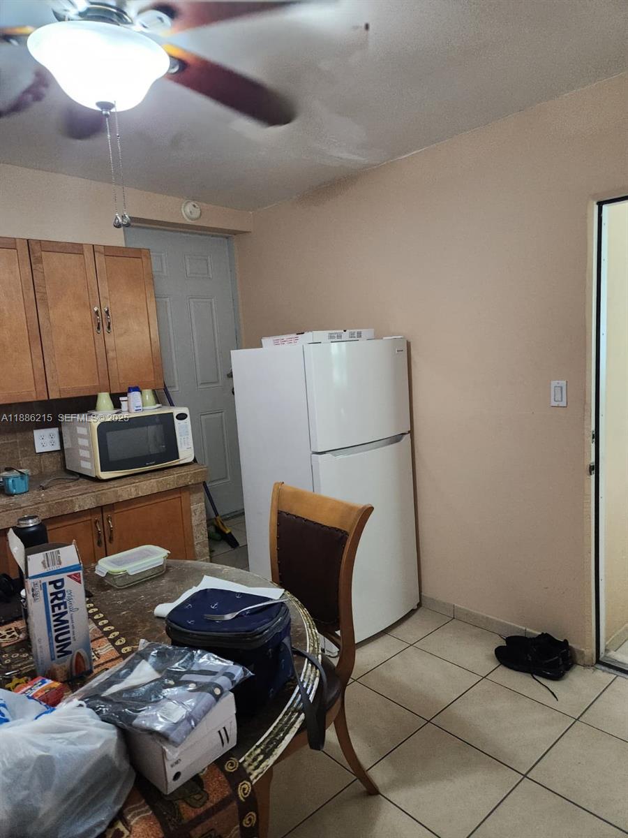 614 East 56th Street Hialeah, FL 33013 - Photo 40 of 78 a backyard of a house with table and chairs