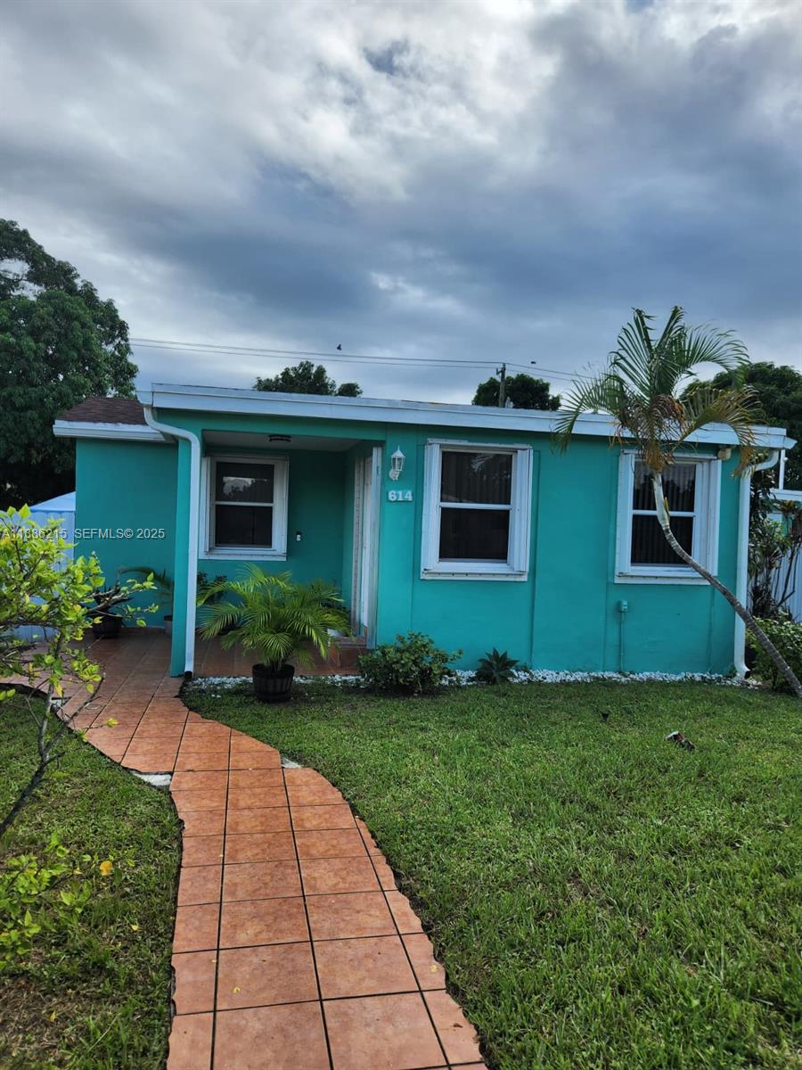 614 East 56th Street Hialeah, FL 33013 - Photo 4 of 78 a front view of house with yard