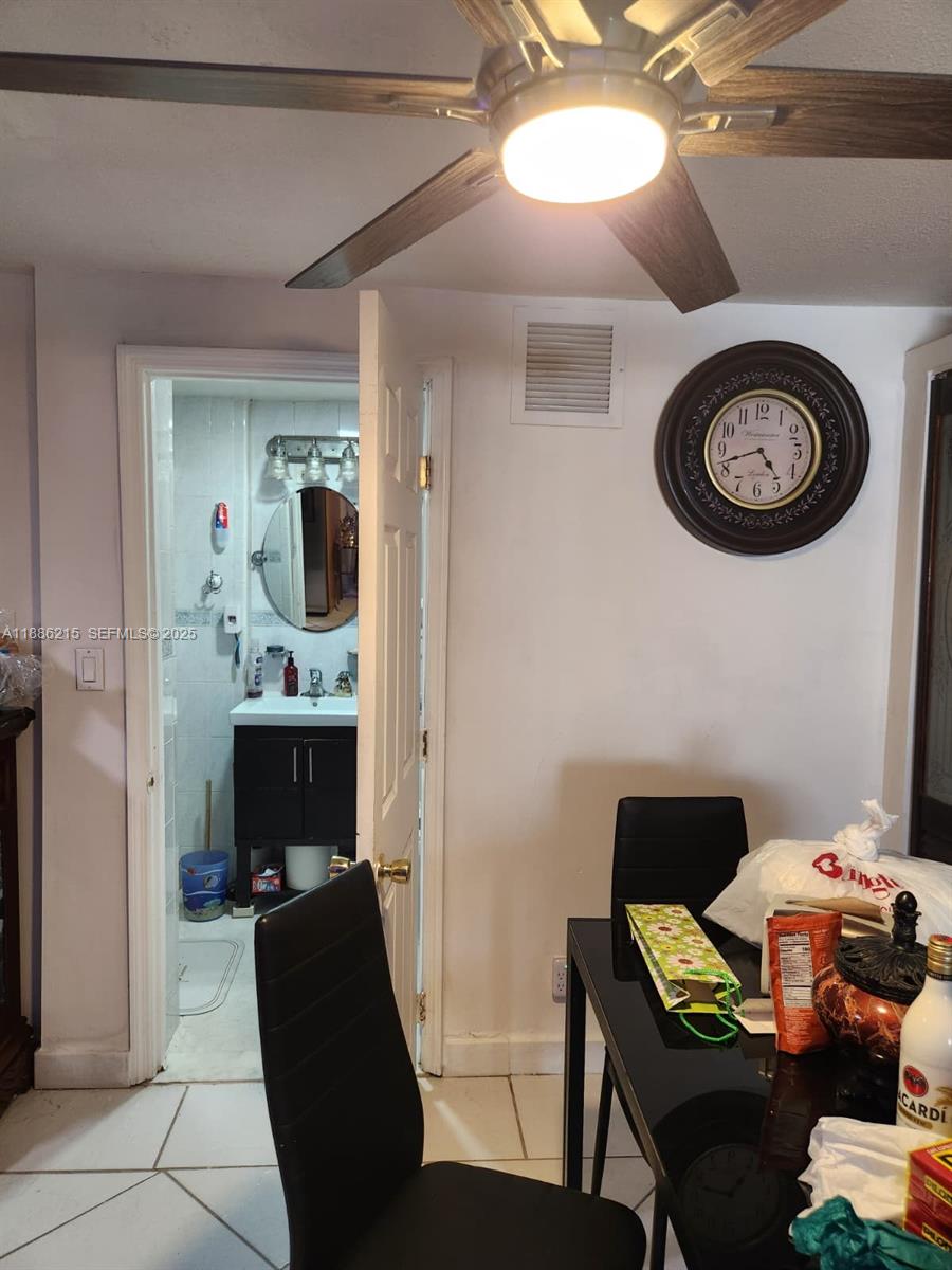 614 East 56th Street Hialeah, FL 33013 - Photo 48 of 78 a bedroom with a bed and a chandelier