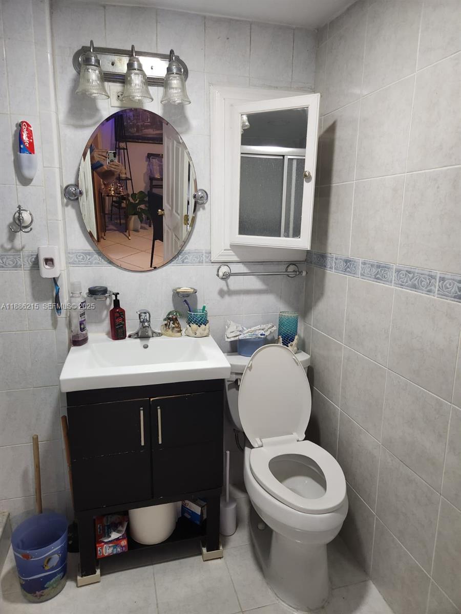 614 East 56th Street Hialeah, FL 33013 - Photo 50 of 78 a bathroom with a sink mirror and toilet
