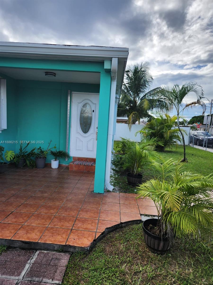 614 East 56th Street Hialeah, FL 33013 - Photo 5 of 78 a front view of a house with garden