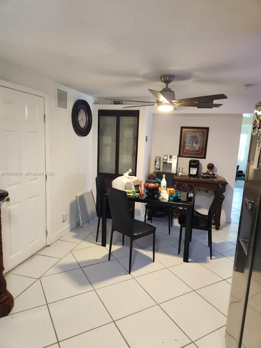 614 East 56th Street Hialeah, FL 33013 - Photo 56 of 78 a living room with furniture a flat screen tv and a table