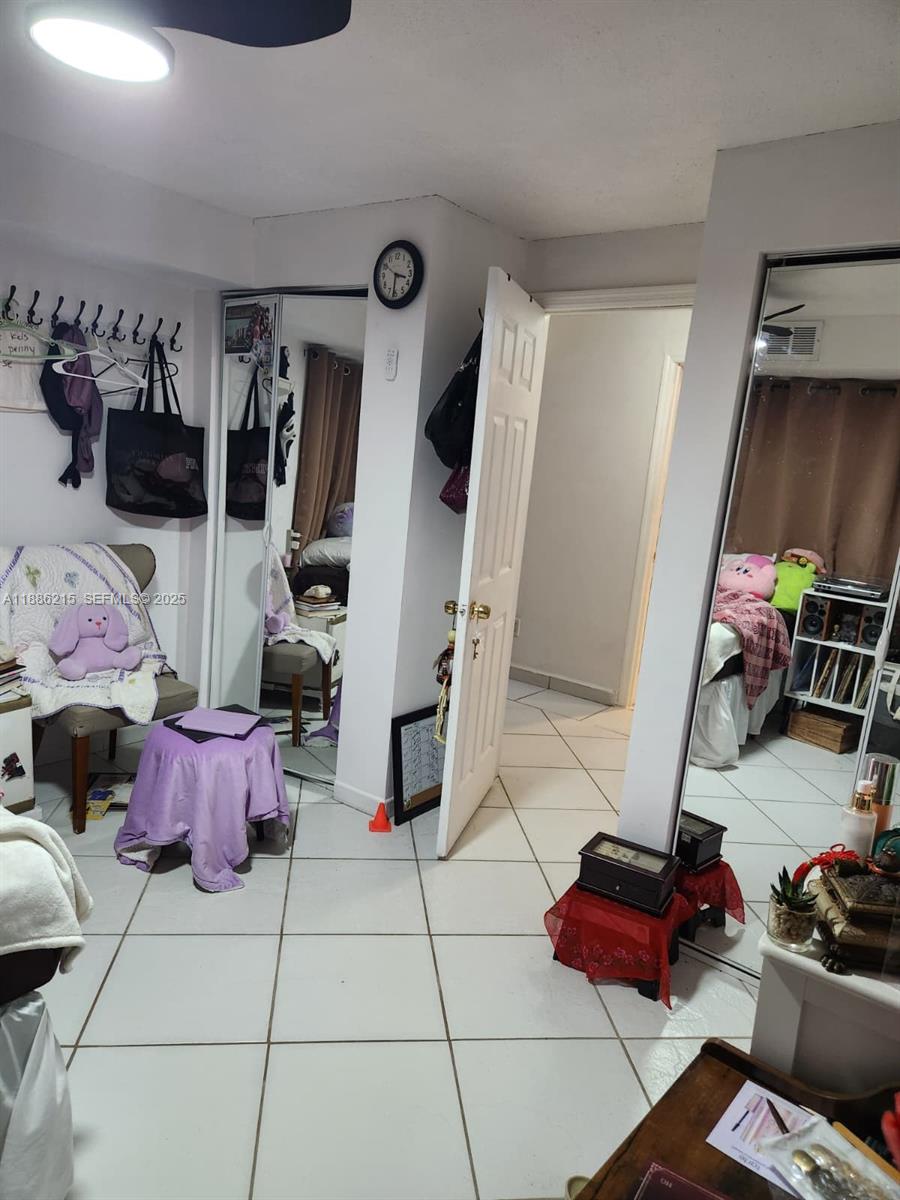 614 East 56th Street Hialeah, FL 33013 - Photo 58 of 78 a bedroom with furniture and workout equipment