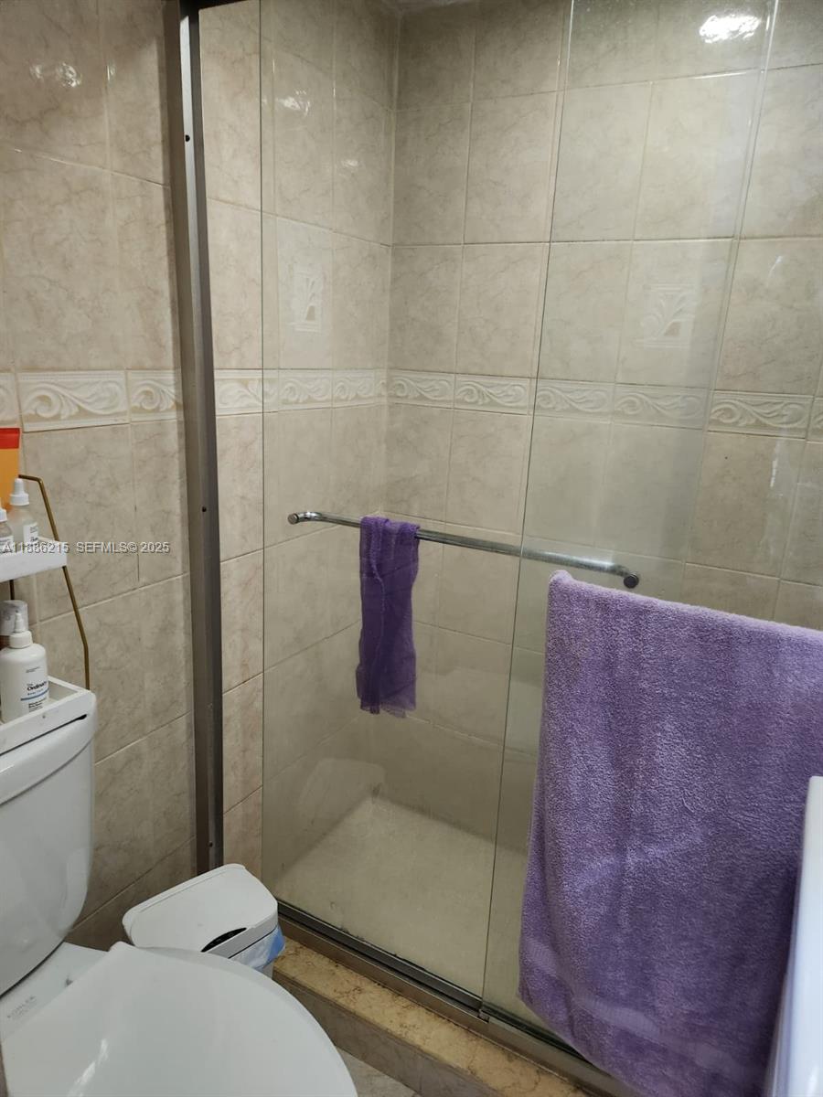 614 East 56th Street Hialeah, FL 33013 - Photo 59 of 78 a bathroom with a shower and a toilet