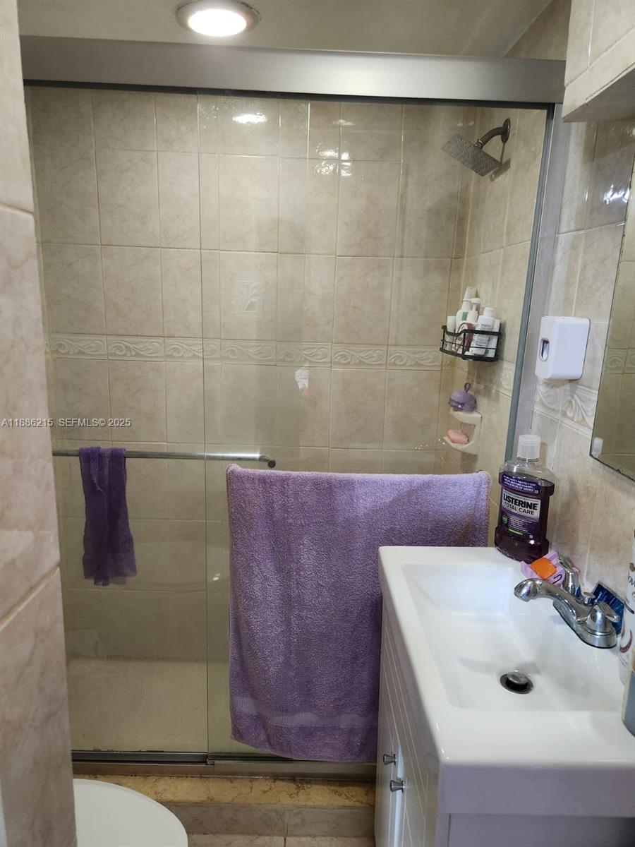 614 East 56th Street Hialeah, FL 33013 - Photo 60 of 78 a bathroom with a sink and a mirror