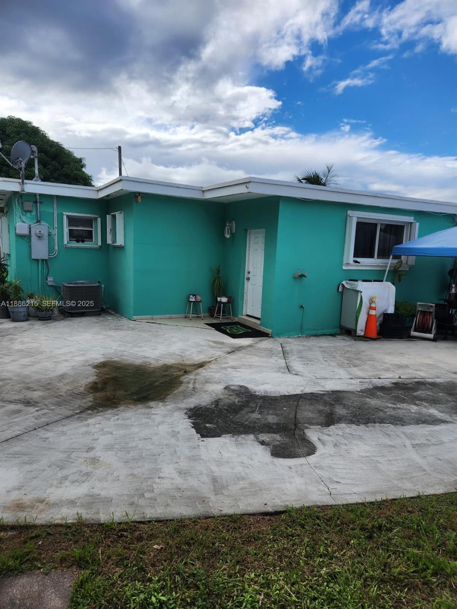 614 East 56th Street Hialeah, FL 33013 - Photo 64 of 78 a front view of a house with garage and outdoor