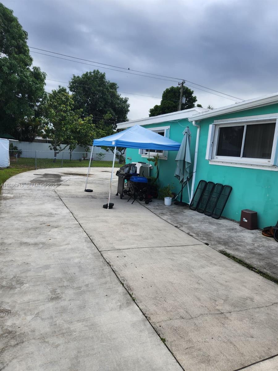 614 East 56th Street Hialeah, FL 33013 - Photo 70 of 78 a front view of a house with a yard and garage