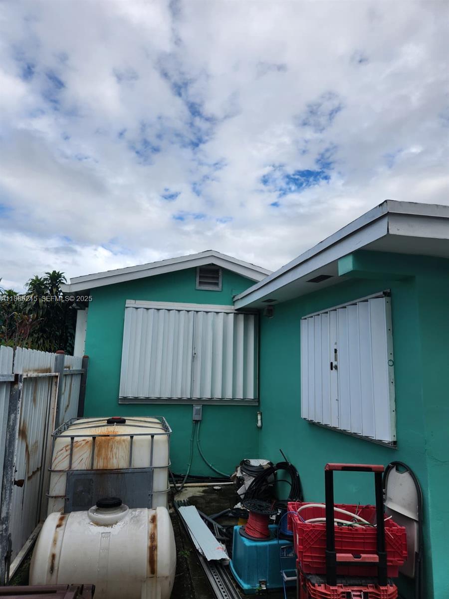 614 East 56th Street Hialeah, FL 33013 - Photo 77 of 78 a backyard of a house with table and chairs with wooden fence