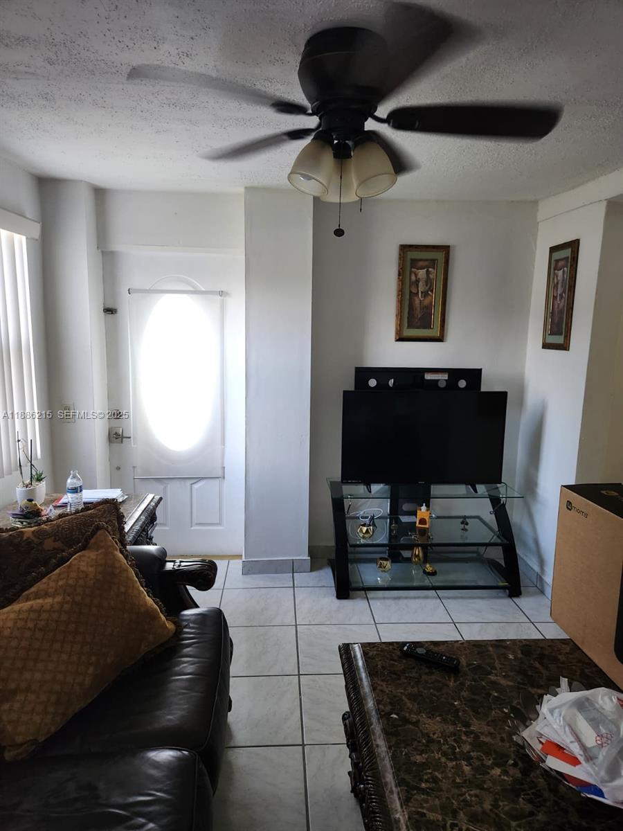 614 East 56th Street Hialeah, FL 33013 - Photo 8 of 78 a living room with furniture and a fireplace