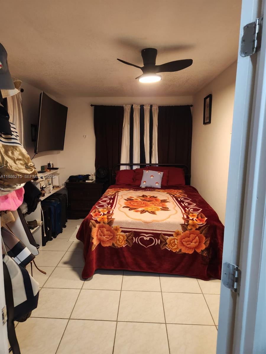 614 East 56th Street Hialeah, FL 33013 - Photo 9 of 78 a bed sitting in a bedroom next to a window