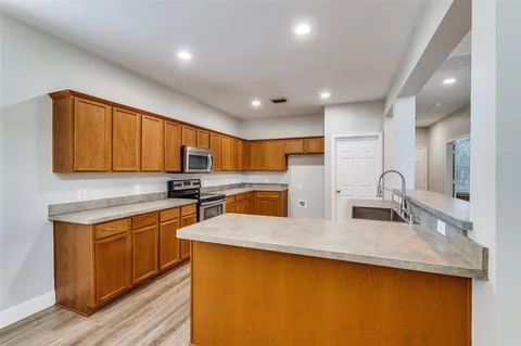 a kitchen with stainless steel appliances granite countertop a sink stove and cabinets