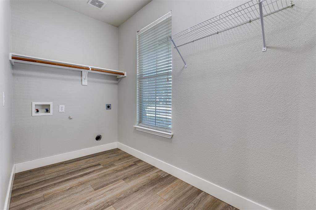 10140 Cedar Lake Drive Providence Village, TX 76227 - Photo 13 of 25 a view of an empty room with wooden floor and a window