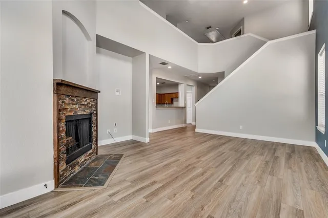 a view of a livingroom with wooden floor and a ceiling fan