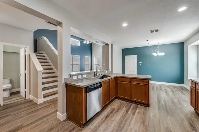 a kitchen with a sink and stove top oven