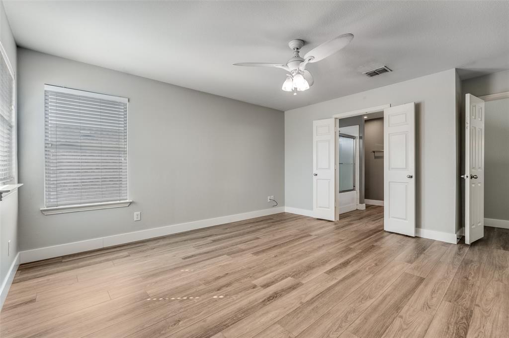 10140 Cedar Lake Drive Providence Village, TX 76227 - Photo 17 of 25 a view of an empty room with wooden floor and a window