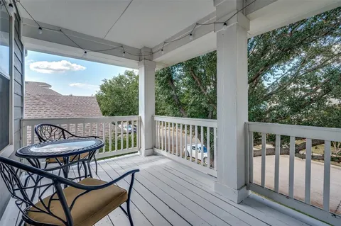 a view of a chair and table on the deck