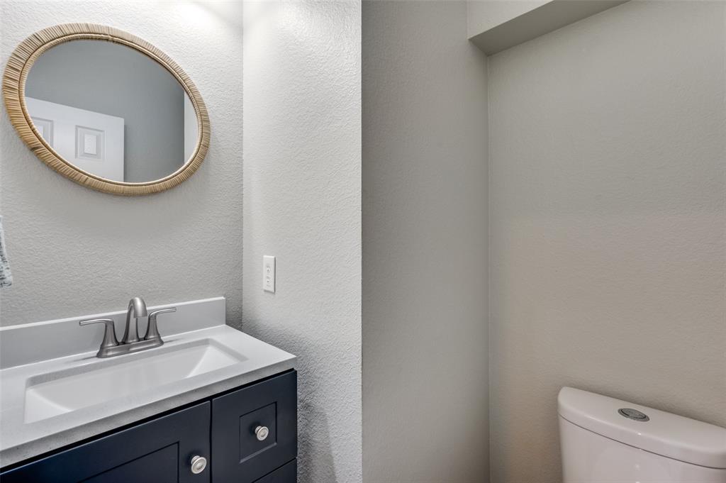 10140 Cedar Lake Drive Providence Village, TX 76227 - Photo 6 of 25 a bathroom with a toilet and a sink