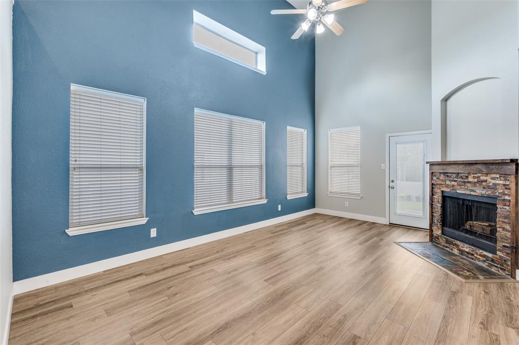 10140 Cedar Lake Drive Providence Village, TX 76227 - Photo 8 of 25 wooden floor fireplace and windows in an empty room