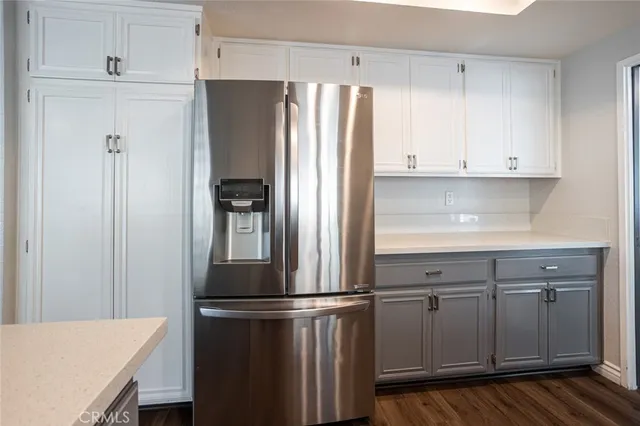 a kitchen with stainless steel appliances a refrigerator and cabinets