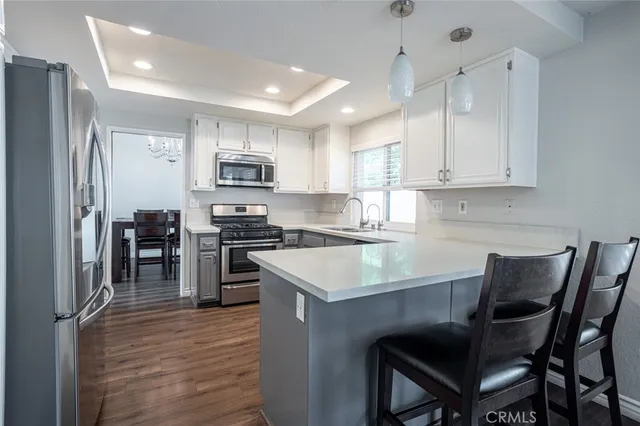 a kitchen with a stove a sink and a refrigerator