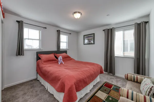 a bedroom with a bed and window