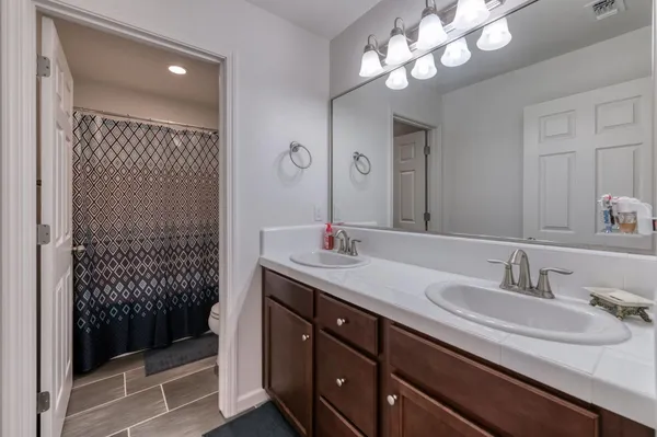 a bathroom with a sink double vanity and shower