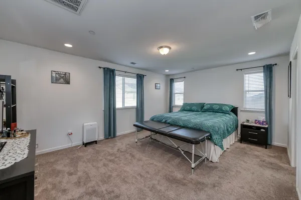 a bedroom with a bed and a tv
