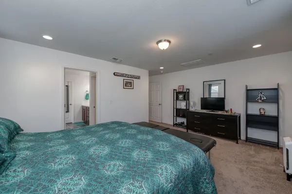 a large bedroom with a bed and furniture