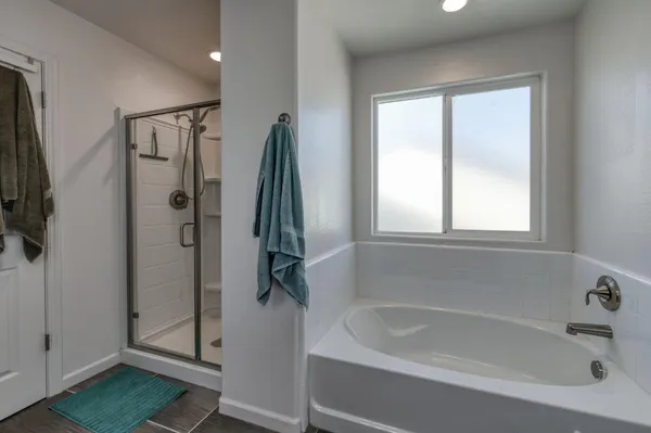 a white bath tub sitting next to a shower