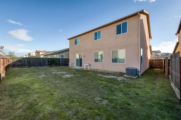 a view of house with backyard