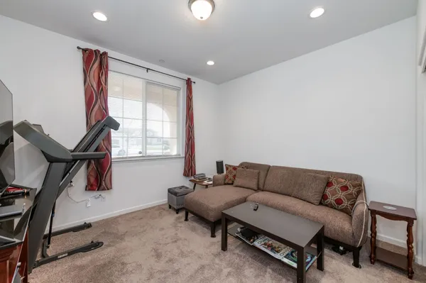 a living room with furniture a window and a flat screen tv