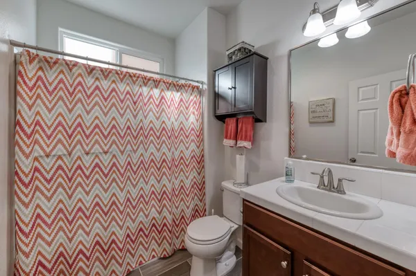 a bathroom with a sink toilet and a mirror