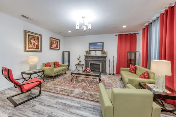 a living room with furniture a fireplace and a flat screen tv