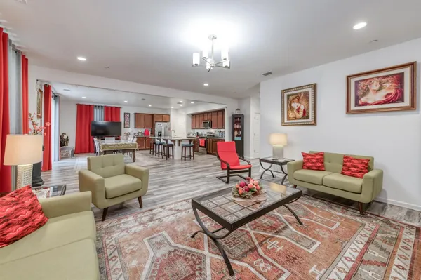 a living room filled with furniture and a chandelier