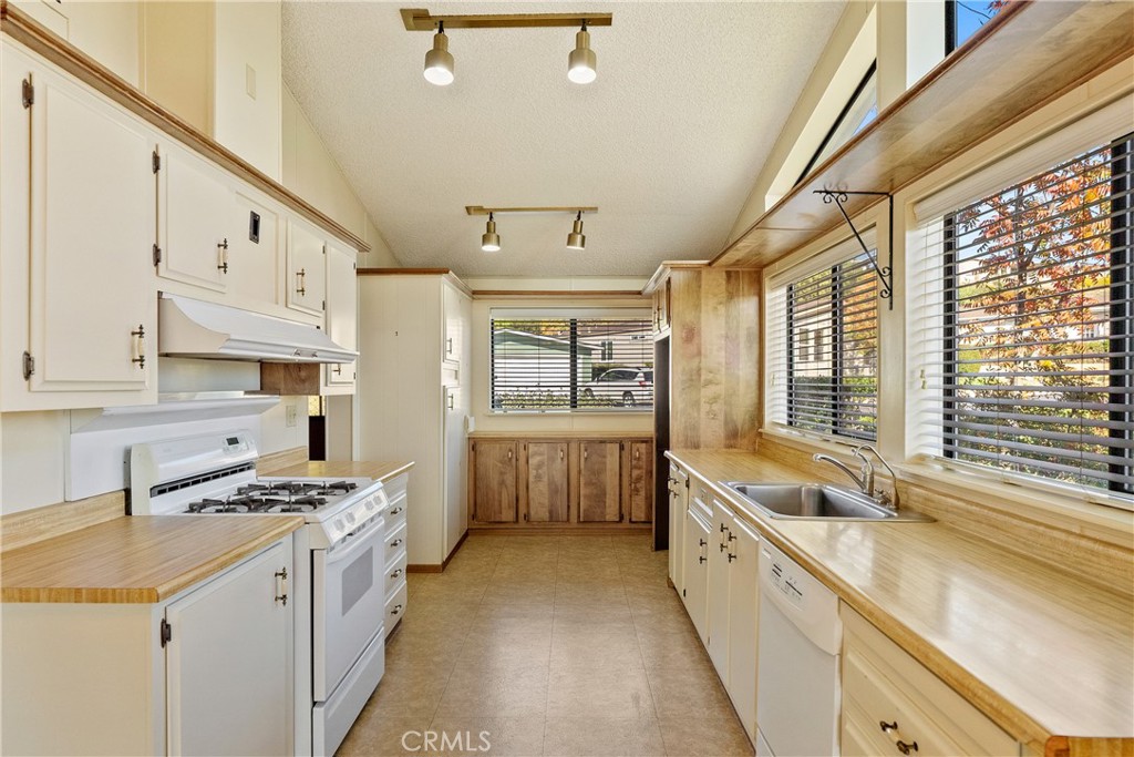 340 Nightingale Avenue Paso Robles, CA 93446 - Photo 17 of 41 a large white kitchen with stainless steel appliances a stove a sink and a large window