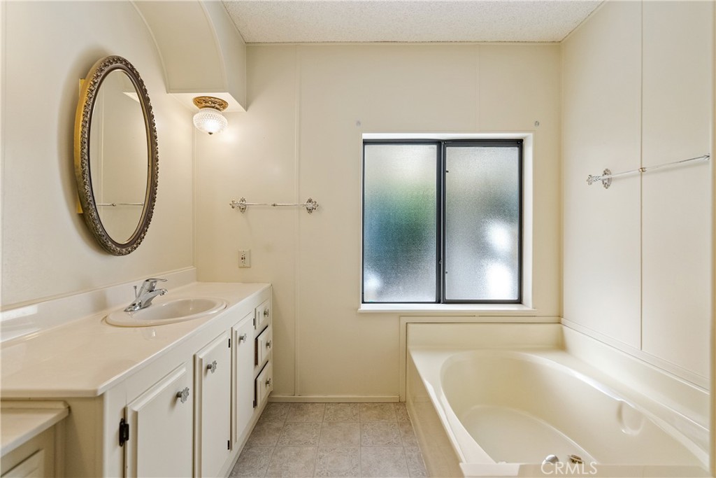 340 Nightingale Avenue Paso Robles, CA 93446 - Photo 28 of 41 a bathroom with a tub sink and mirror
