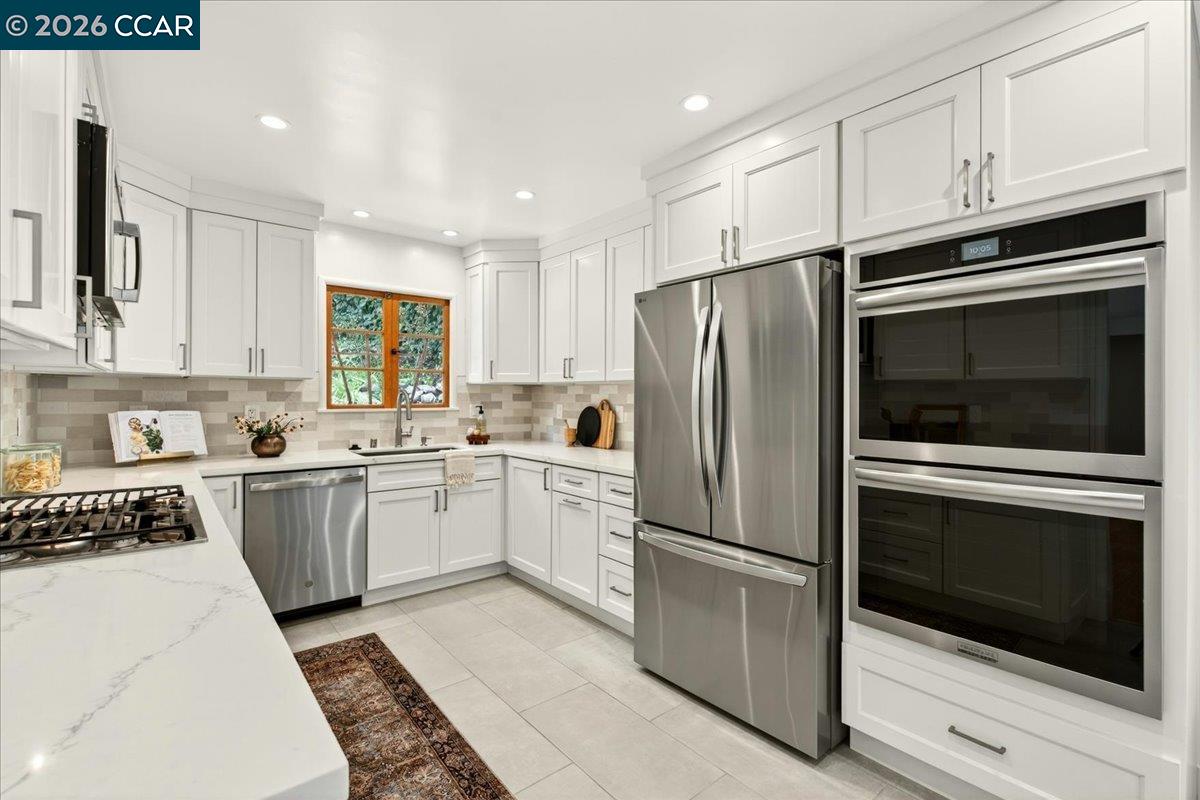 24 Las Vegas Road Orinda, CA 94563 - Photo 12 of 47 a kitchen with cabinets stainless steel appliances and window