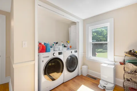 a utility room with sink dryer and washer