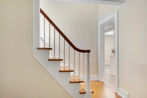 a view of entryway and hall with wooden floor