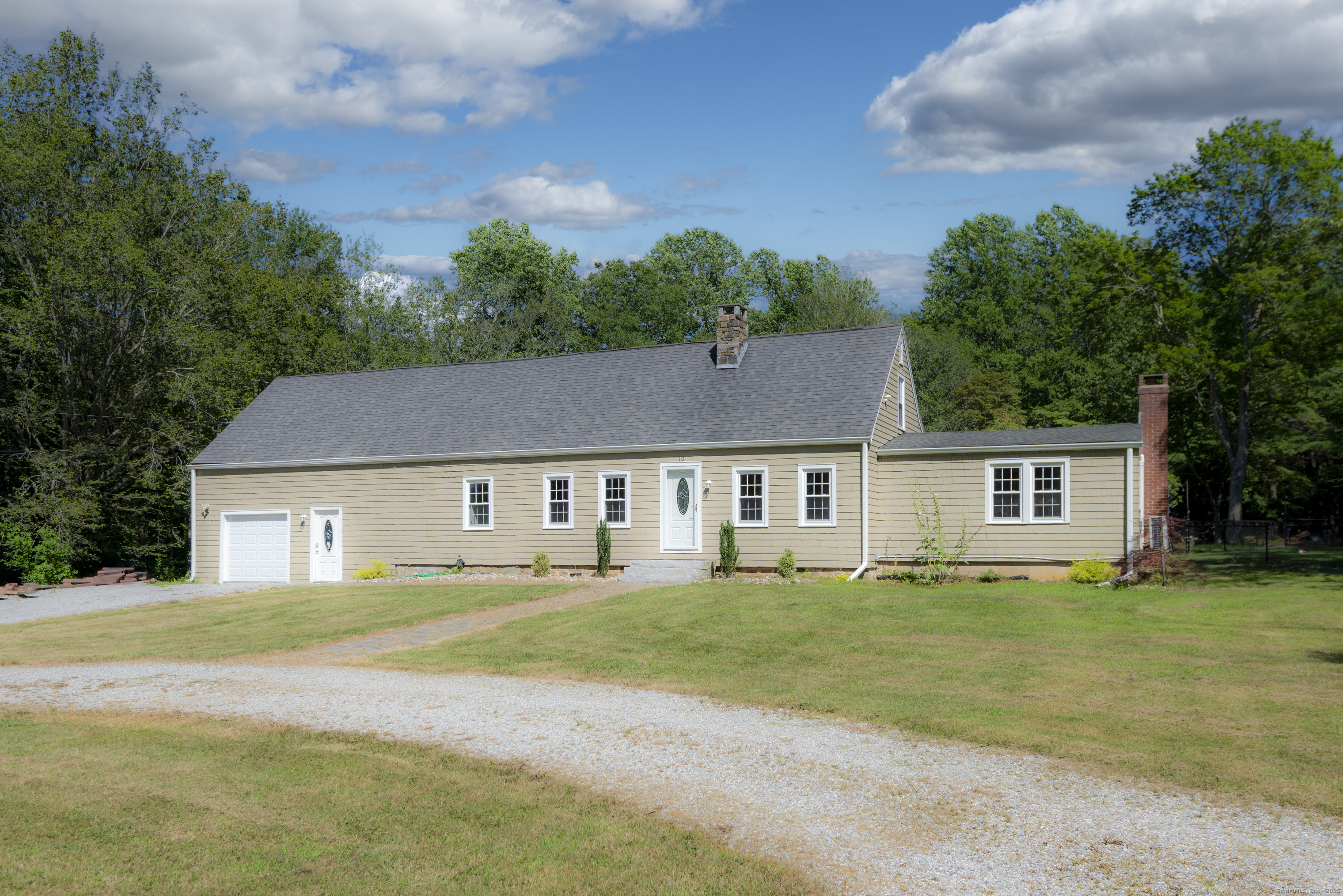 112 Cedar Swamp Road Deep River, CT 06417 - Photo 2 of 37 a house that has a big yard with plants and large trees