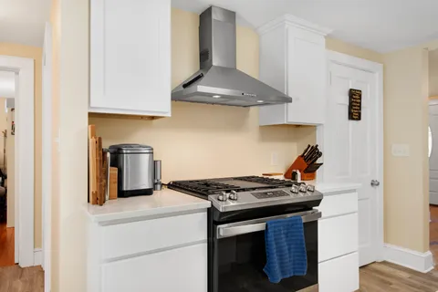 a kitchen with stainless steel appliances granite countertop a stove and a refrigerator