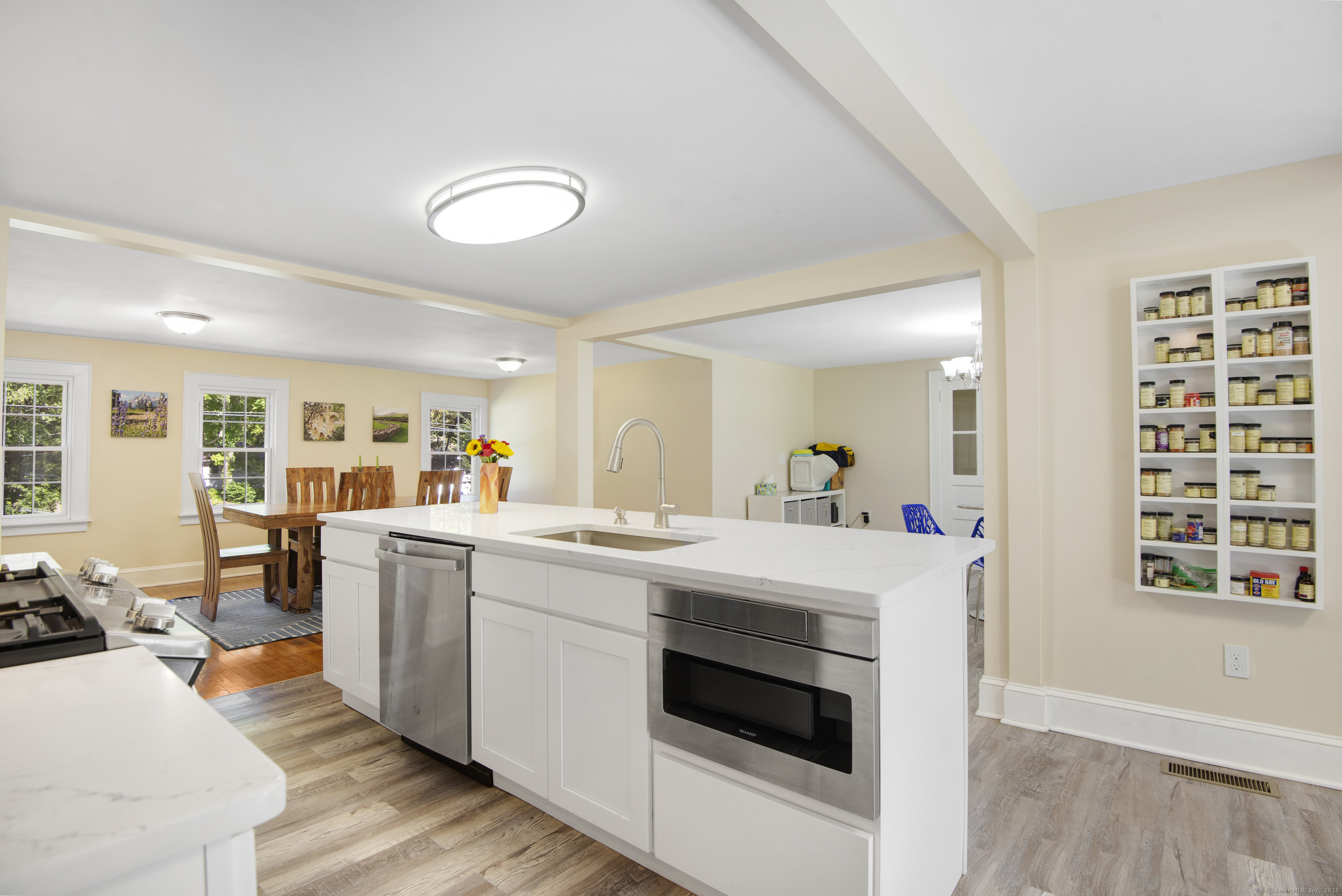 112 Cedar Swamp Road Deep River, CT 06417 - Photo 23 of 37 a kitchen with a stove a refrigerator and a dining table with wooden floor