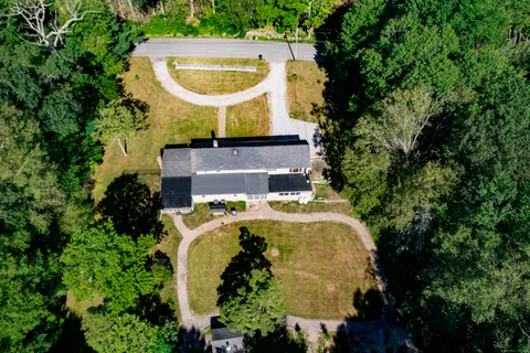 an aerial view of a house with outdoor space