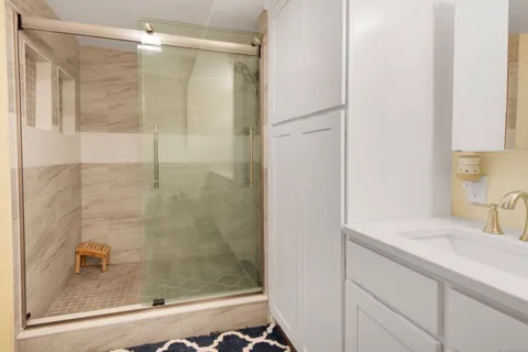 a bathroom with a shower and a sink