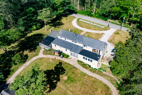 an aerial view of a house with a swimming pool