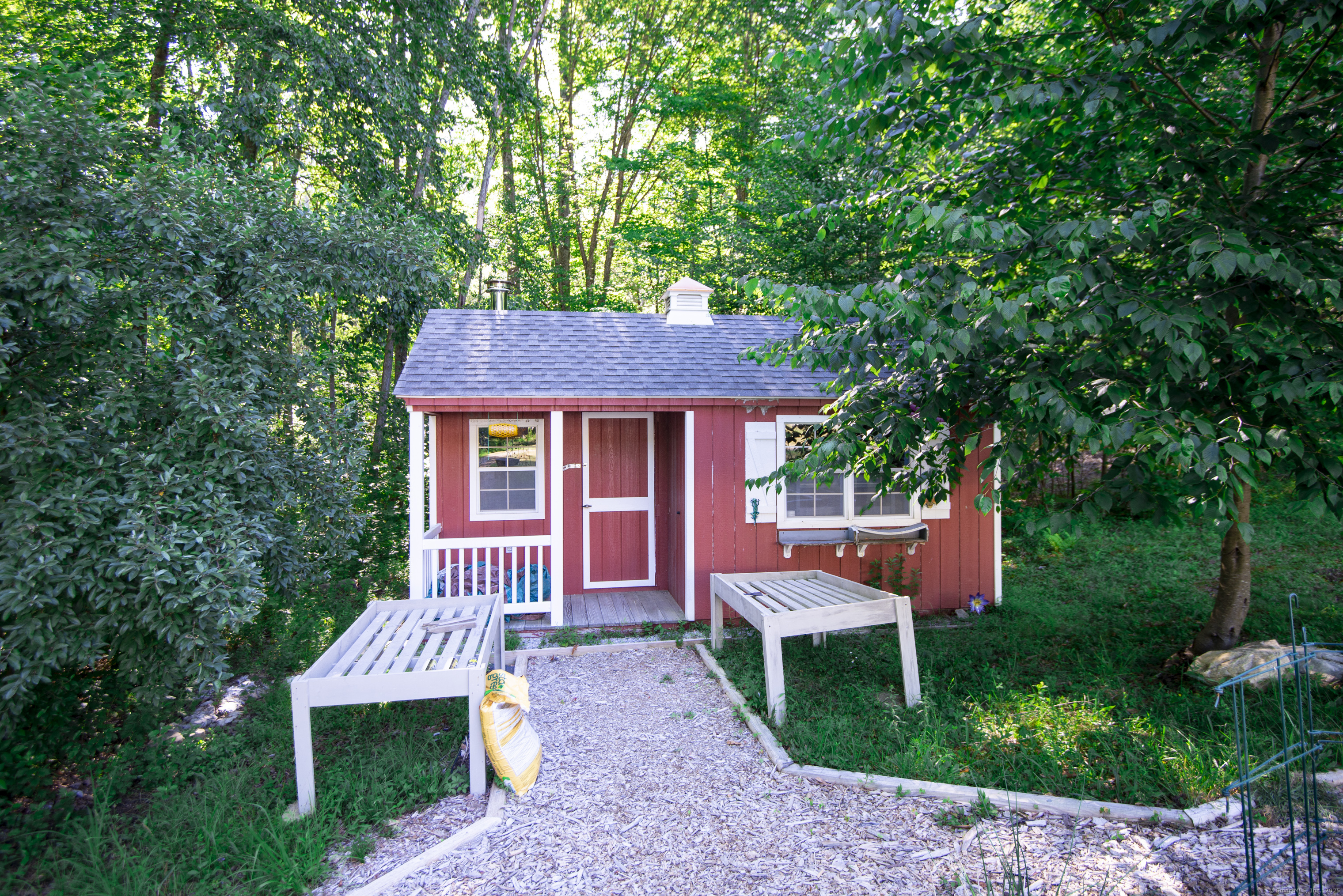 112 Cedar Swamp Road Deep River, CT 06417 - Photo 33 of 37 a front view of a house with a garden and porch
